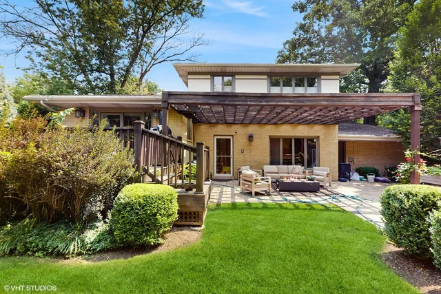 a view of a house with a yard and furniture