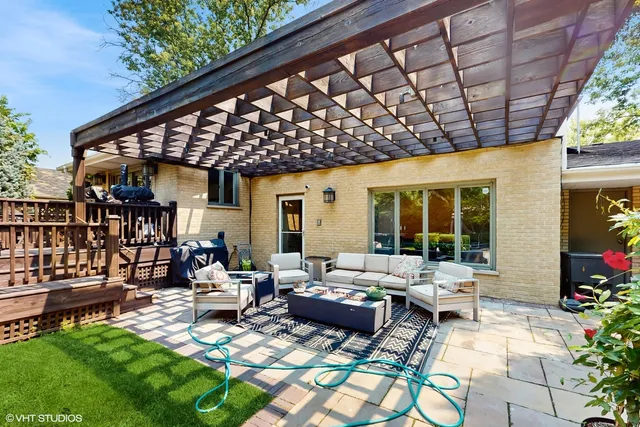 a view of a patio with couches table and chairs and potted plants