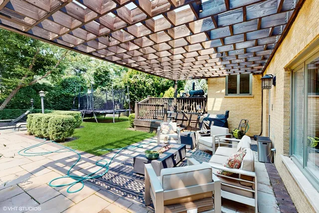 a view of a chairs and table in backyard of the house