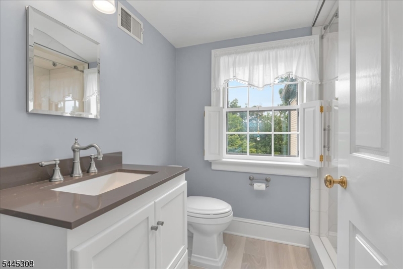 911 Ravine Road Port Murray, NJ 07865 - Photo 21 of 50 a bathroom with a sink vanity granite toilet and a mirror