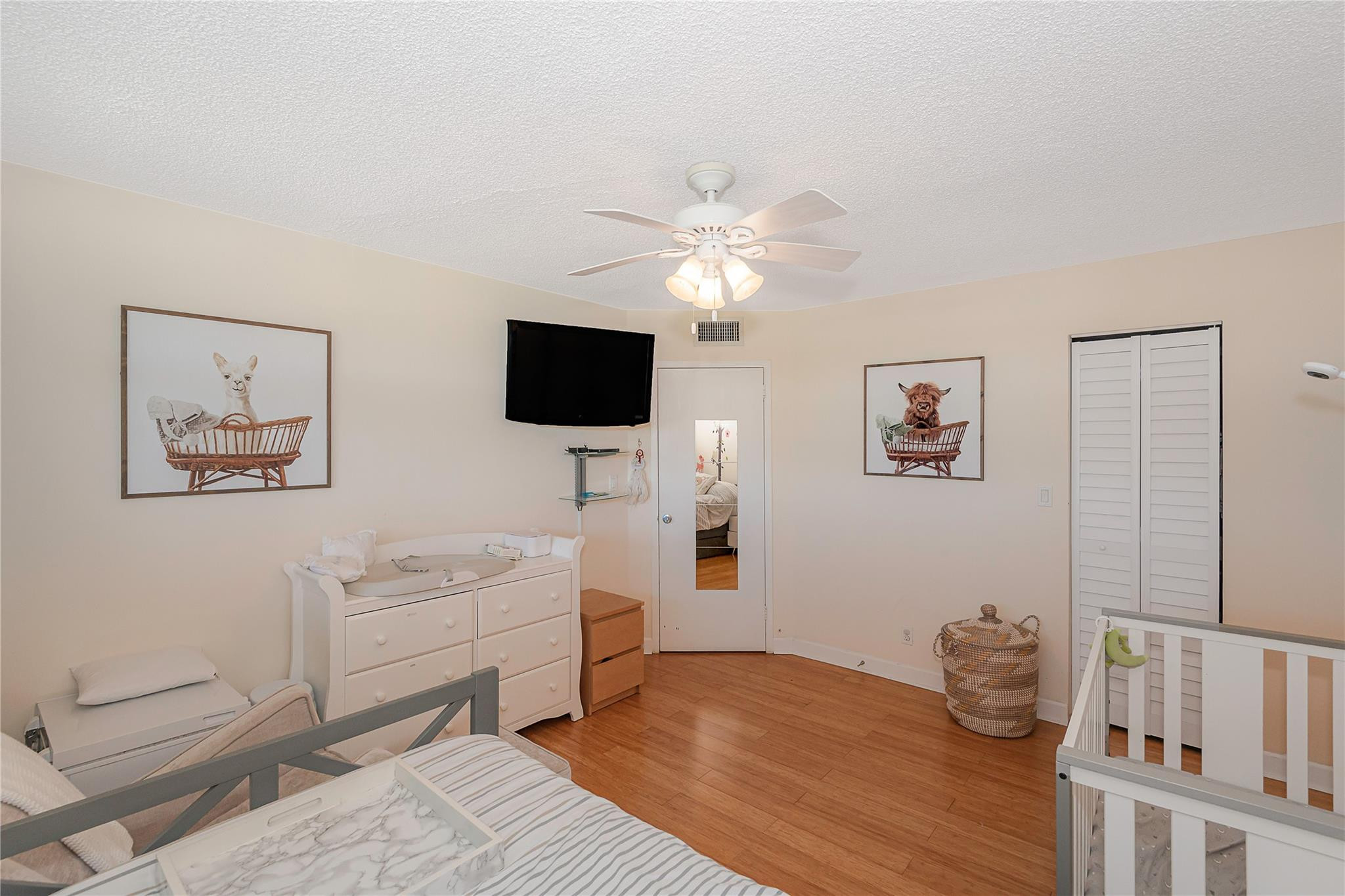 5300 Northeast 24th Terrace, Unit 512 Fort Lauderdale, FL 33308 - Photo 11 of 35 a bedroom with furniture and a flat screen tv