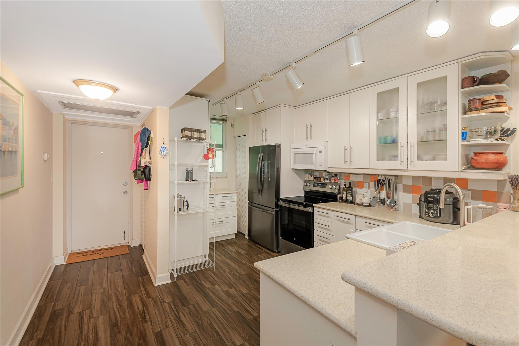 5300 Northeast 24th Terrace, Unit 512 Fort Lauderdale, FL 33308 - Photo 2 of 35 a kitchen with refrigerator cabinets and wooden floor