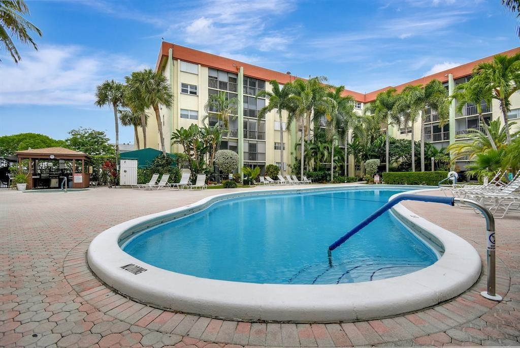 5300 Northeast 24th Terrace, Unit 512 Fort Lauderdale, FL 33308 - Photo 23 of 35 a view of swimming pool with outdoor seating and green space