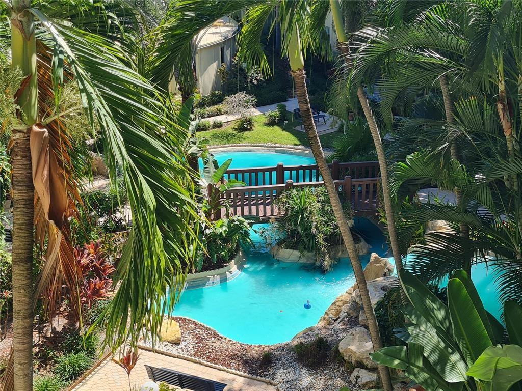 5300 Northeast 24th Terrace, Unit 512 Fort Lauderdale, FL 33308 - Photo 27 of 35 a view of a swimming pool with a garden