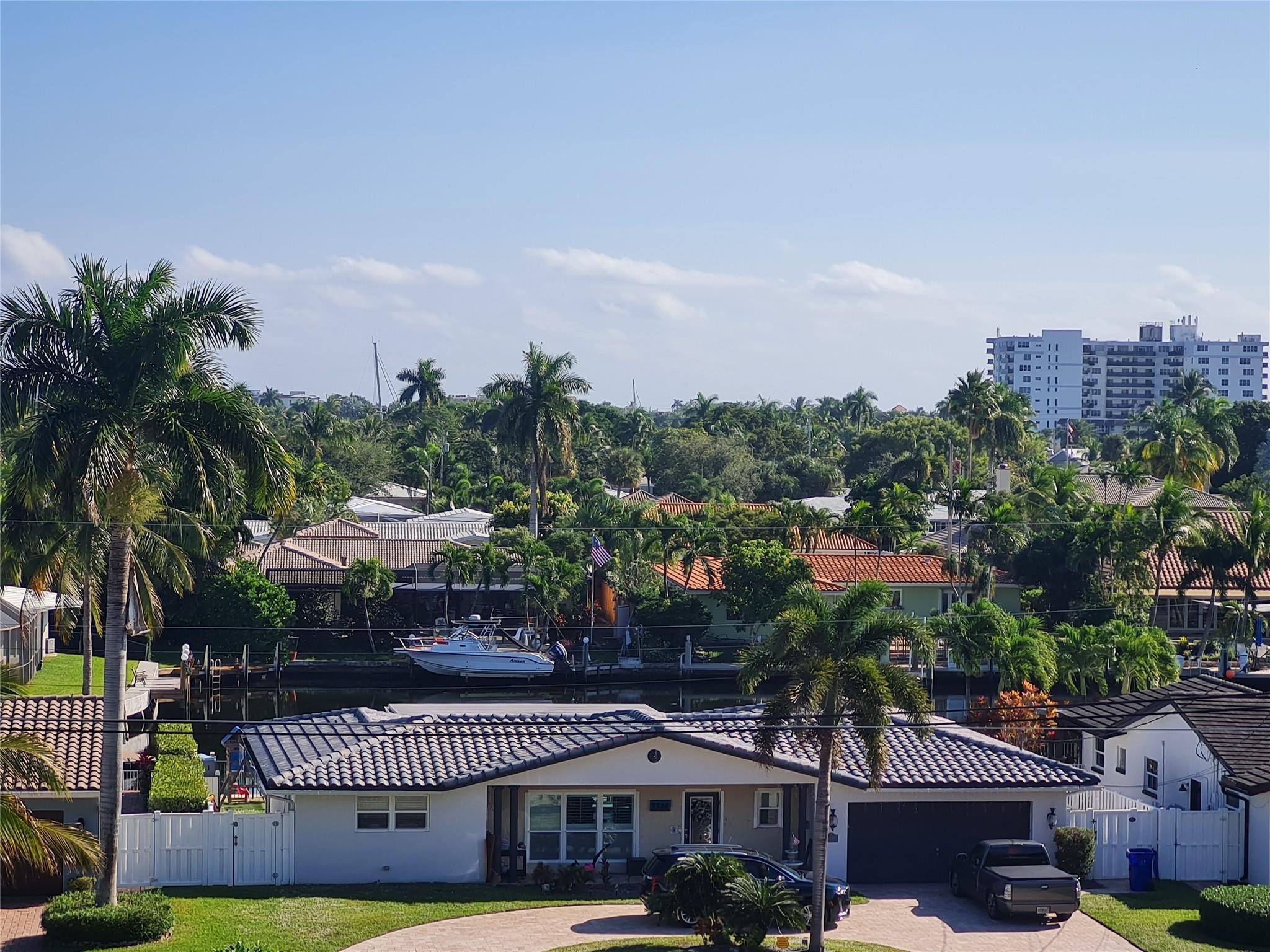 5300 Northeast 24th Terrace, Unit 512 Fort Lauderdale, FL 33308 - Photo 34 of 35 a front view of a building with garden and patio
