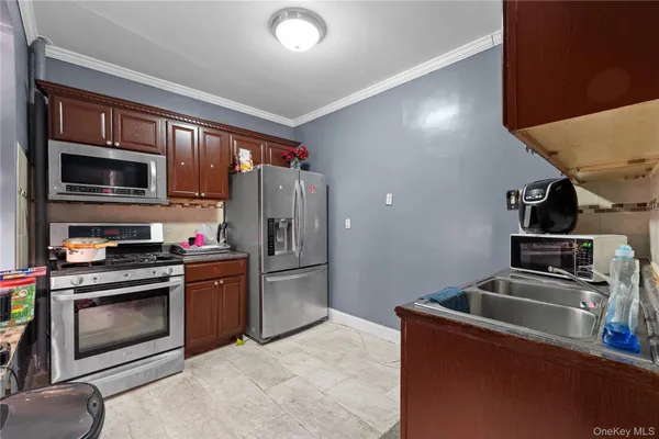 a kitchen with stainless steel appliances granite countertop a refrigerator stove and oven
