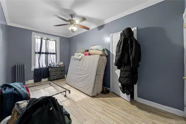 a bed room with a bed and a ceiling fan