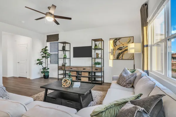a living room with furniture and wooden floor