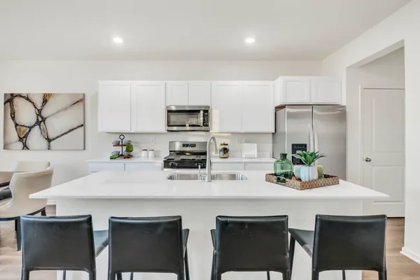 a kitchen with appliances a sink and cabinets