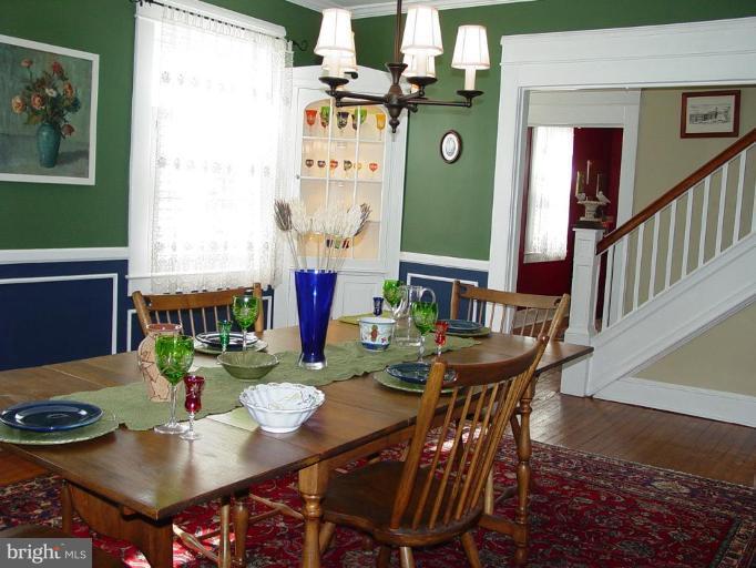 6517 Sherwood Road Baltimore, MD 21239 - Photo 8 of 29 a view of a dining room with furniture and a potted plant