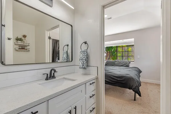 a en suite bathroom with a sink and a mirror