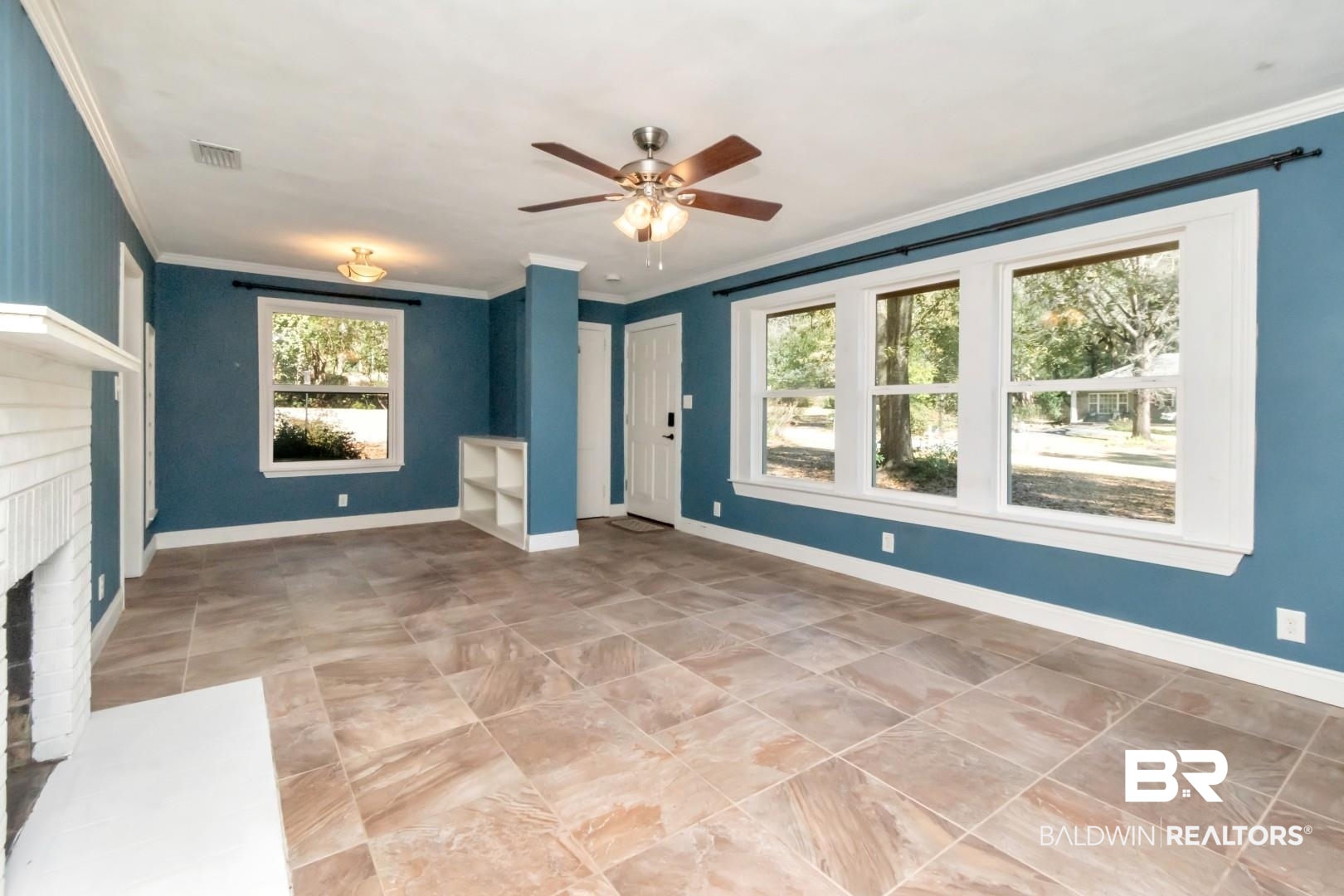 410 St John Place Mobile, AL 36609 - Photo 5 of 32 Unfurnished living room with a ceiling fan, a brick fireplace, and crown molding