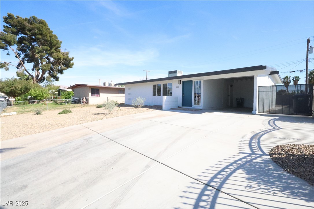 View of front of home with concrete driveway, stuc