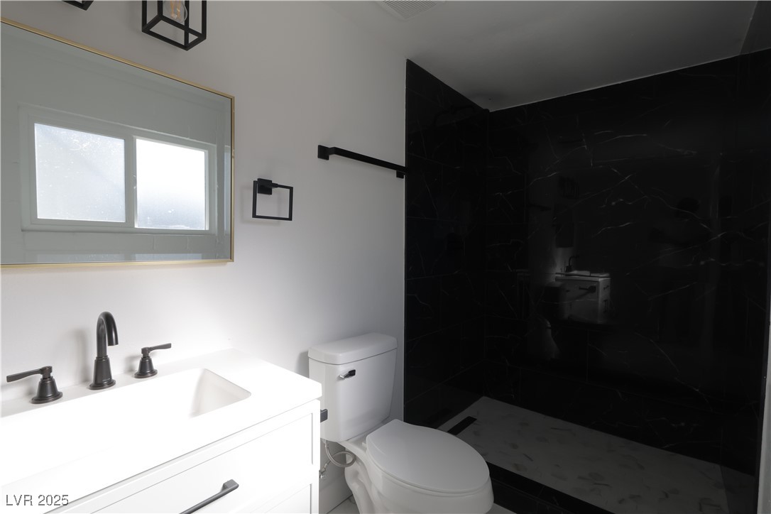 3115 Wright Avenue North Las Vegas, NV 89030 - Photo 13 of 20 Studio Full bath featuring toilet, a tile shower,