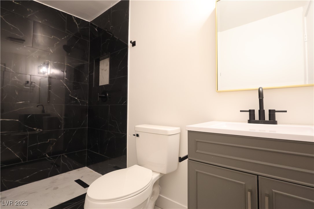3115 Wright Avenue North Las Vegas, NV 89030 - Photo 10 of 20 Bathroom featuring toilet, vanity, and a tile show