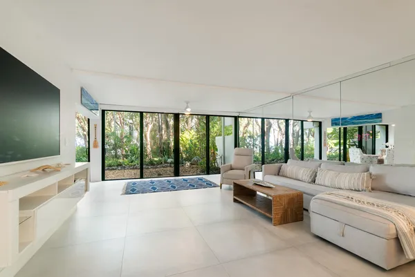 a spacious bedroom with a large bed and a large window