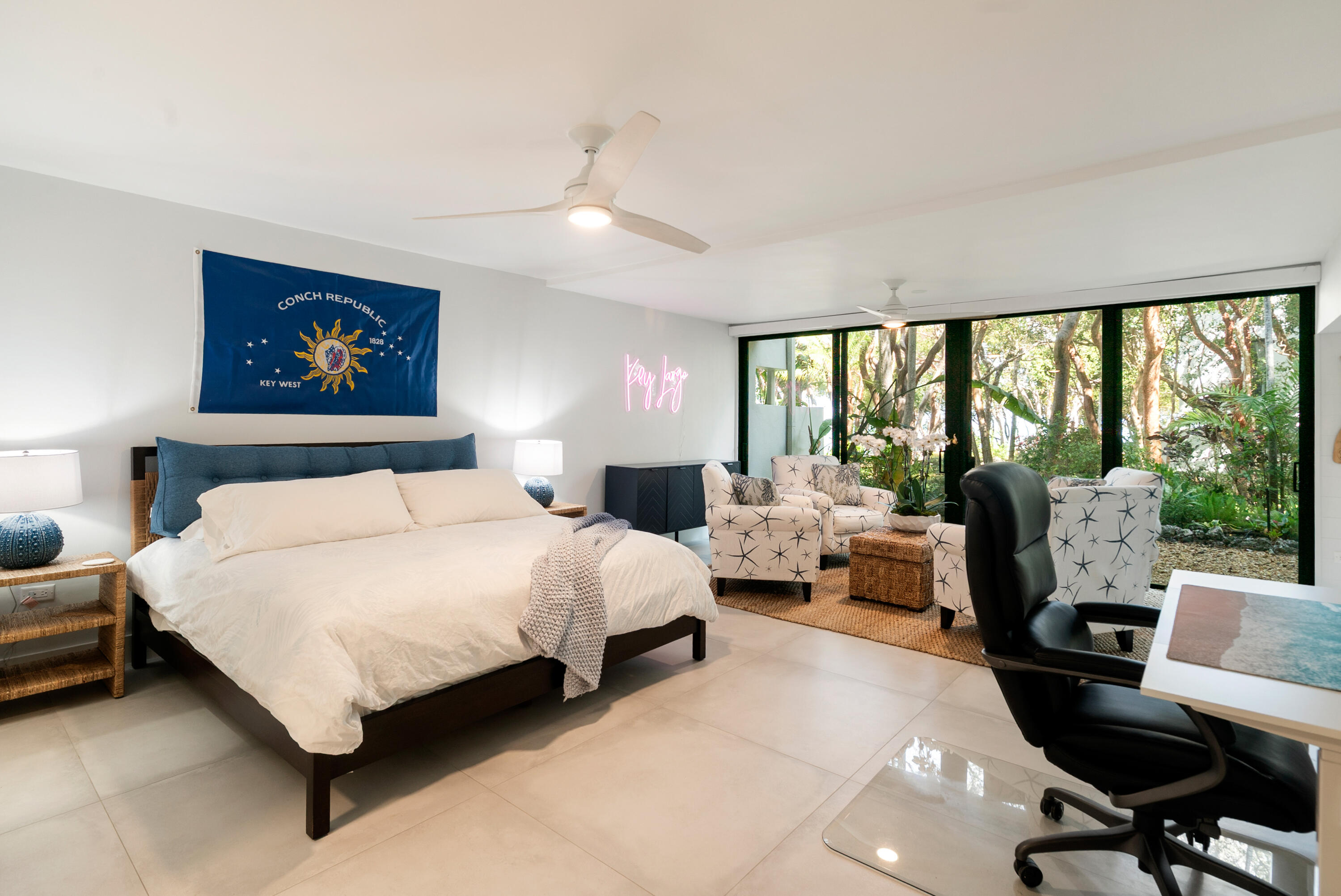 97652 Overseas Highway, Unit M4 Key Largo, FL 33037 - Photo 14 of 44 a spacious bedroom with a bed and a large window