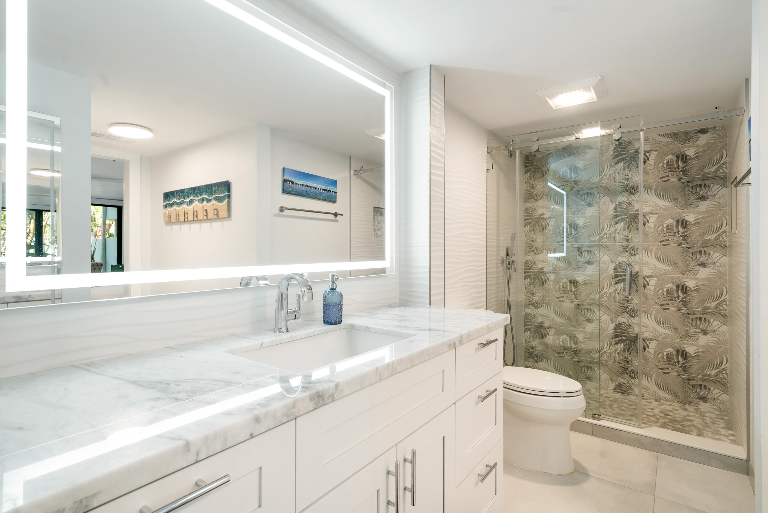 97652 Overseas Highway, Unit M4 Key Largo, FL 33037 - Photo 19 of 44 a bathroom with a granite countertop sink a toilet and a shower