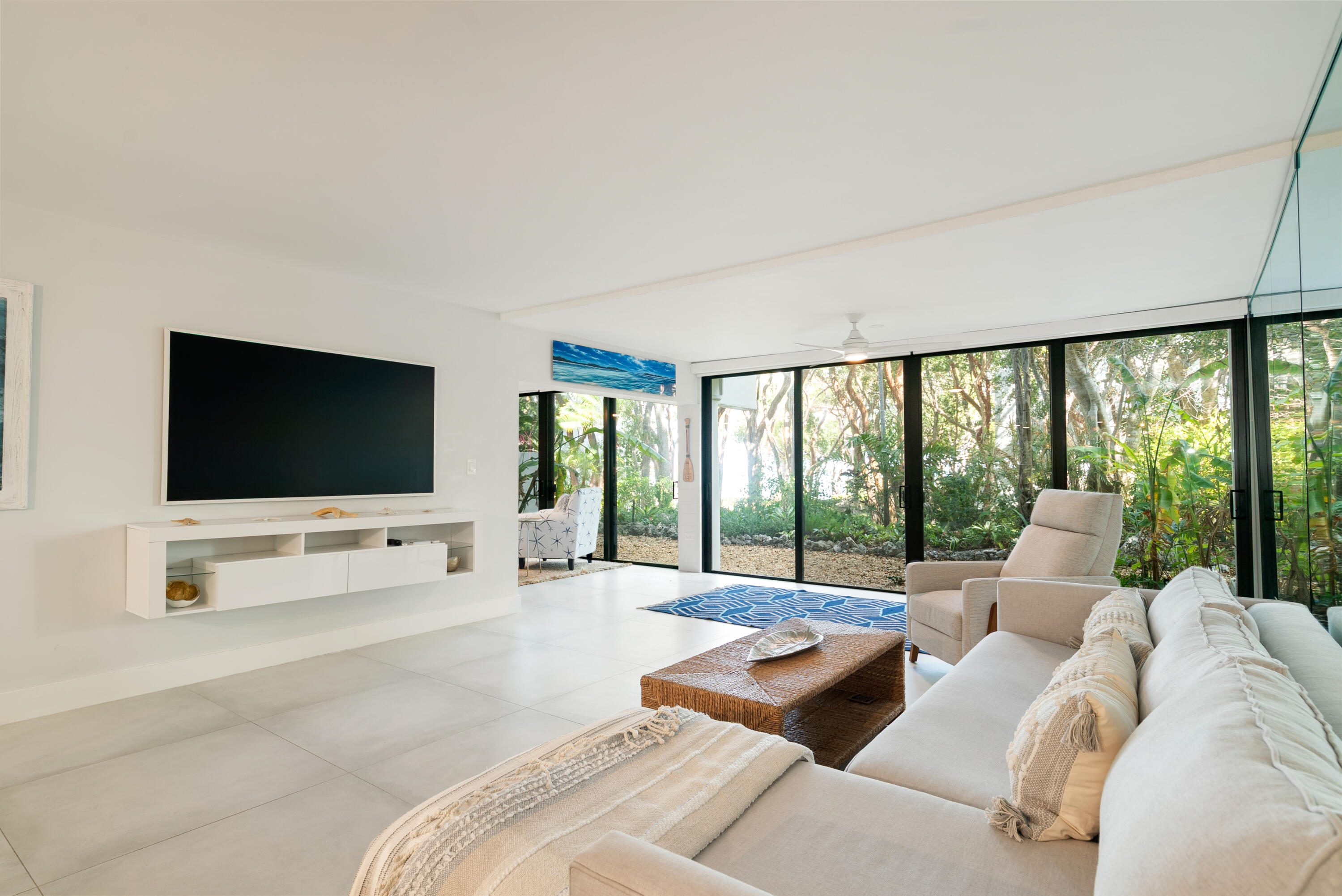 97652 Overseas Highway, Unit M4 Key Largo, FL 33037 - Photo 7 of 44 a living room with furniture and a flat screen tv