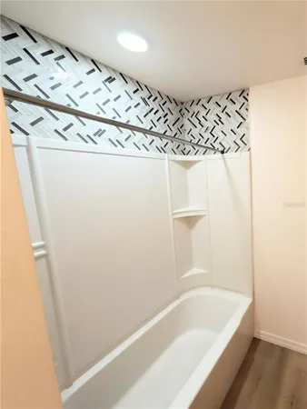 a bathroom with a bathtub and a shower