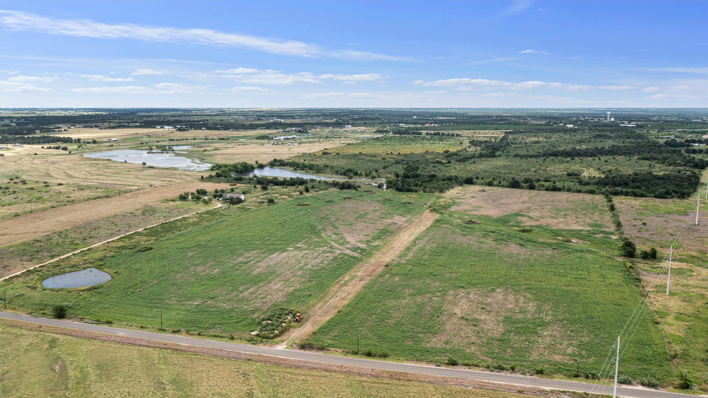 3315 County Road 463 Elgin, TX 78621 - Photo 10 of 32 Acquire expansive acreage featuring two tranquil ponds, ideal for agricultural pursuits or developing a private estate.