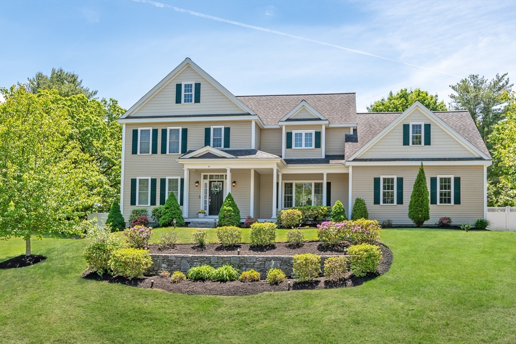 a front view of a house with a yard table and chairs