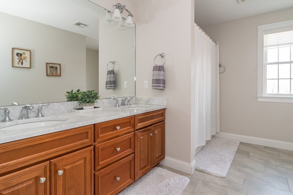 6 Hickory Road Natick, MA 01760 - Photo 19 of 35 a spacious bathroom with a granite countertop sink and a mirror
