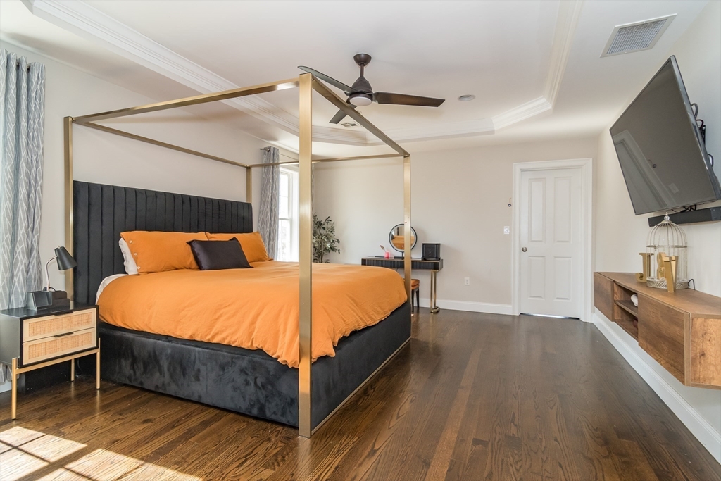 6 Hickory Road Natick, MA 01760 - Photo 20 of 35 a bed room with a bed and a flat tv screen on a dresser