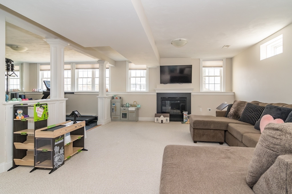 6 Hickory Road Natick, MA 01760 - Photo 27 of 35 a living room with furniture and a fireplace