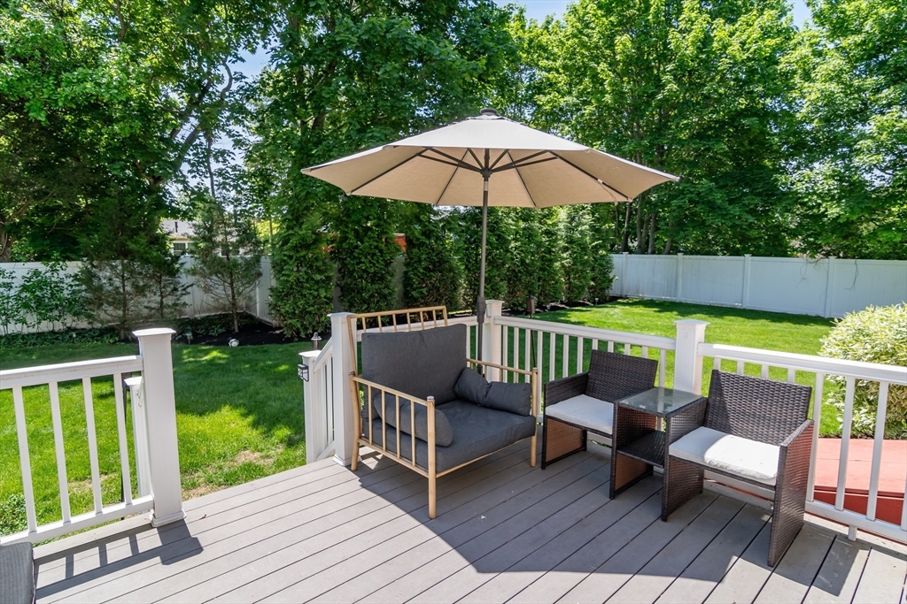 6 Hickory Road Natick, MA 01760 - Photo 30 of 35 a view of a wooden deck with furniture and a garden