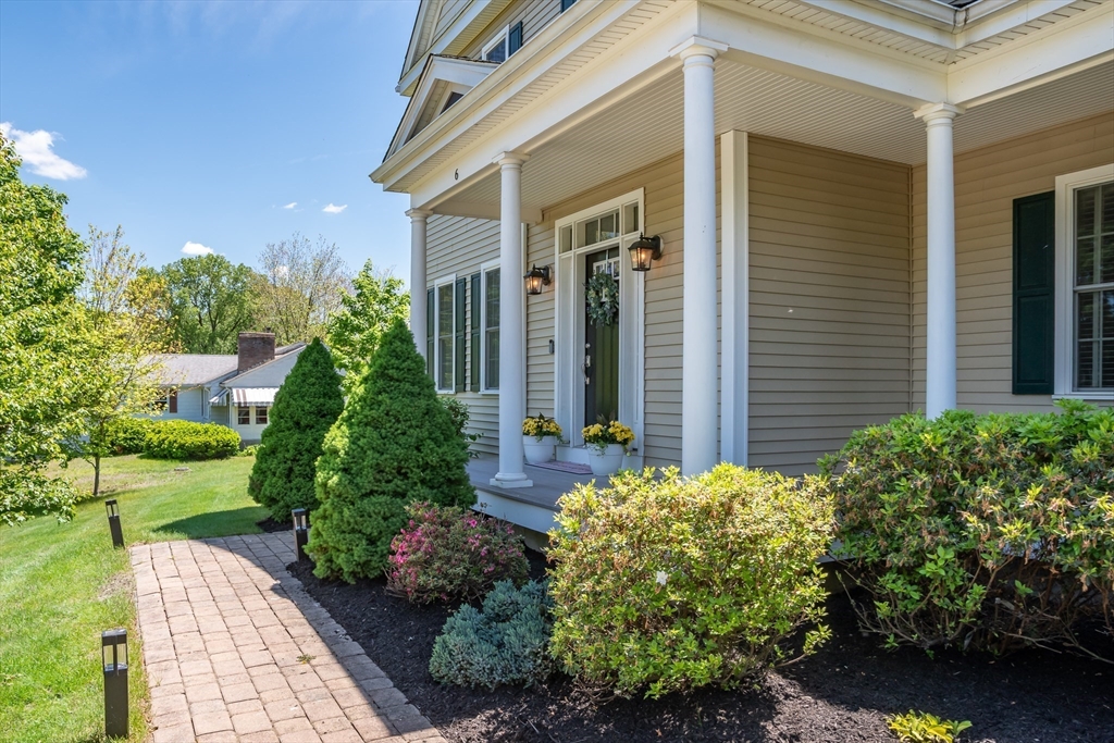 6 Hickory Road Natick, MA 01760 - Photo 4 of 35 a front view of a house with garden