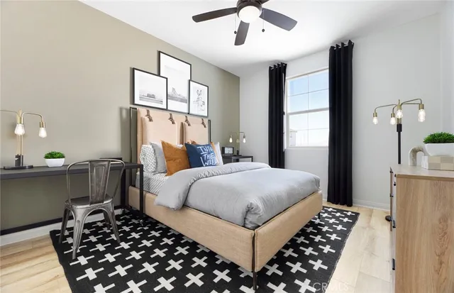 a bedroom with a large bed and a chandelier