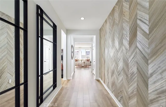 a view of a hallway with wooden floor and furniture