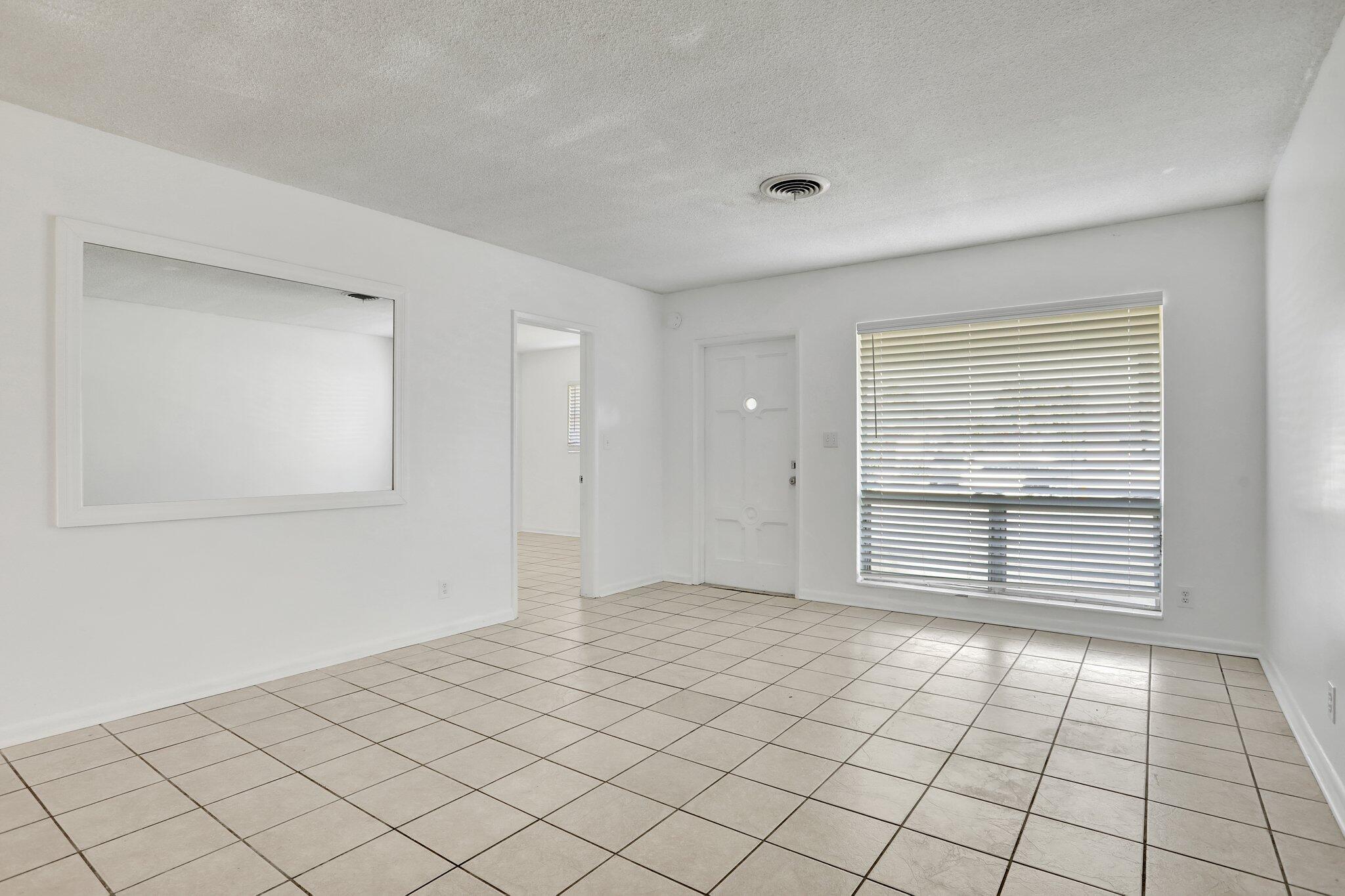 2540-2550 Northeast 10th Court, Unit 12 Pompano Beach, FL 33062 - Photo 13 of 25 a view of an empty room and window