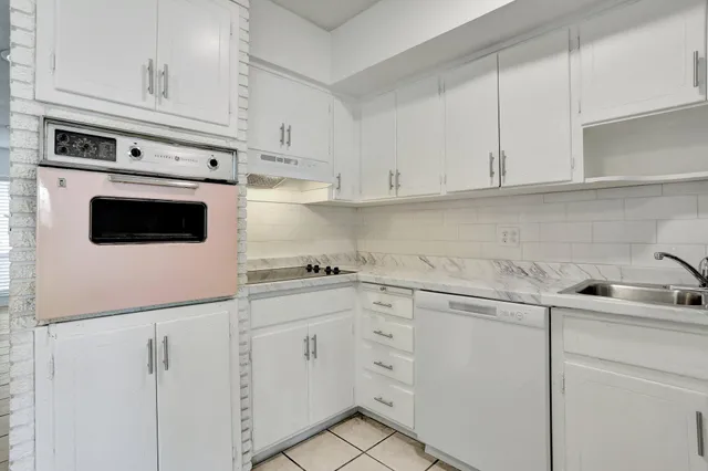 a kitchen with white cabinets sink and white appliances