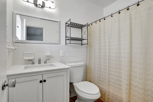 a bathroom with a sink a mirror and a toilet