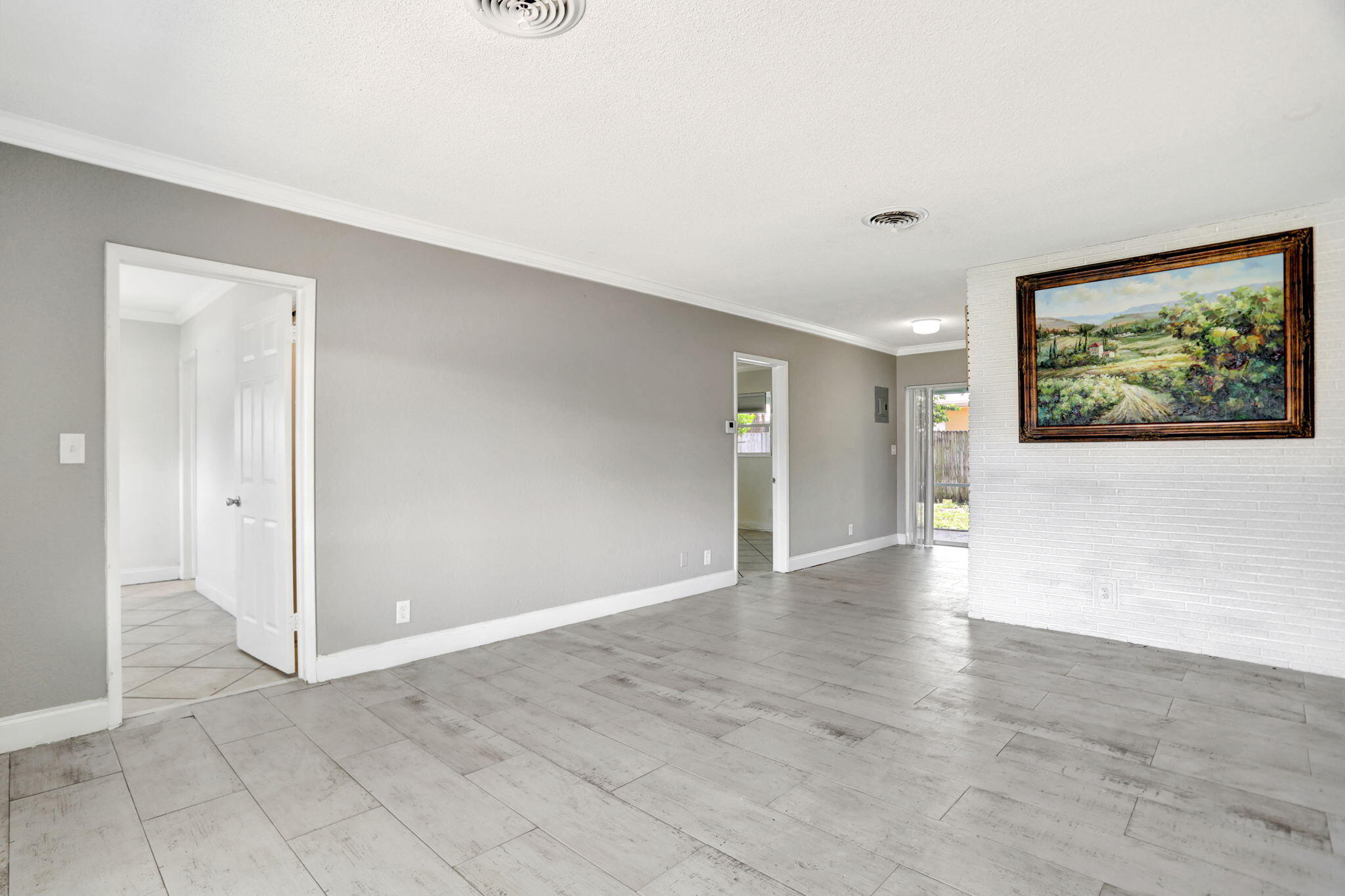2540-2550 Northeast 10th Court, Unit 12 Pompano Beach, FL 33062 - Photo 3 of 25 wooden floor in an empty room