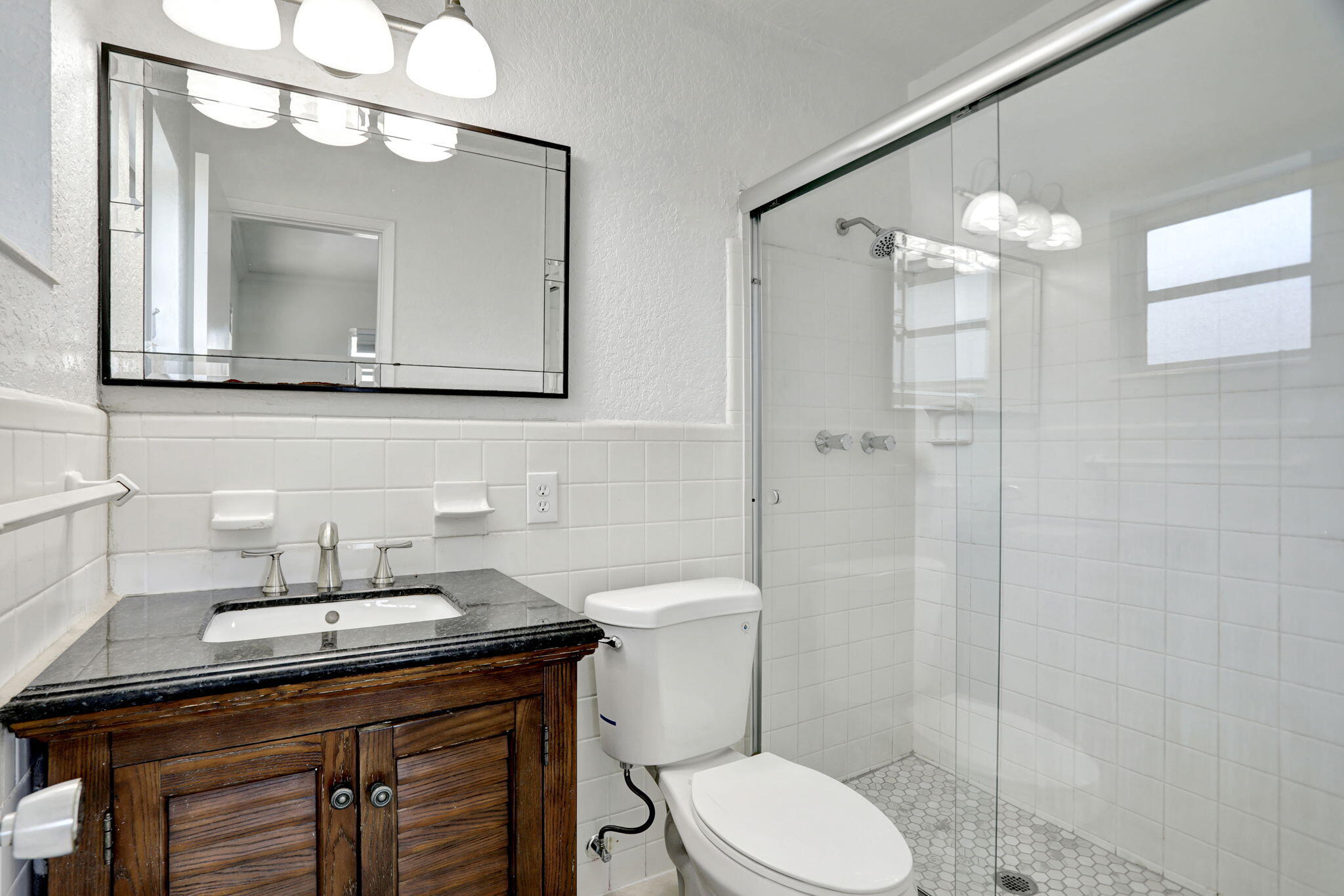 2540-2550 Northeast 10th Court, Unit 12 Pompano Beach, FL 33062 - Photo 7 of 25 a bathroom with a sink a toilet and a mirror