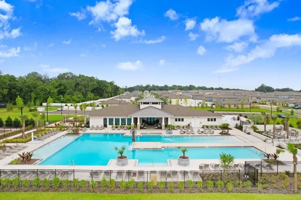 a view of swimming pool with outdoor seating and city view