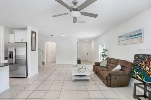 a living room with furniture and a kitchen island