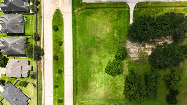 an aerial view of residential houses with outdoor space and river