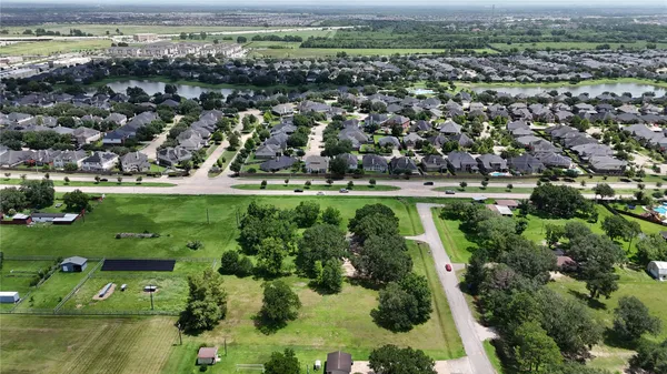 an aerial view of residential houses with outdoor space