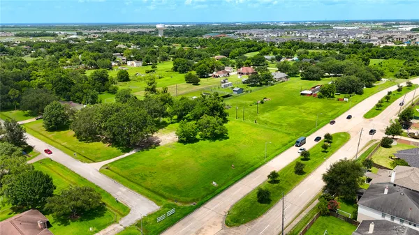 an aerial view of a city with lots of green and trees