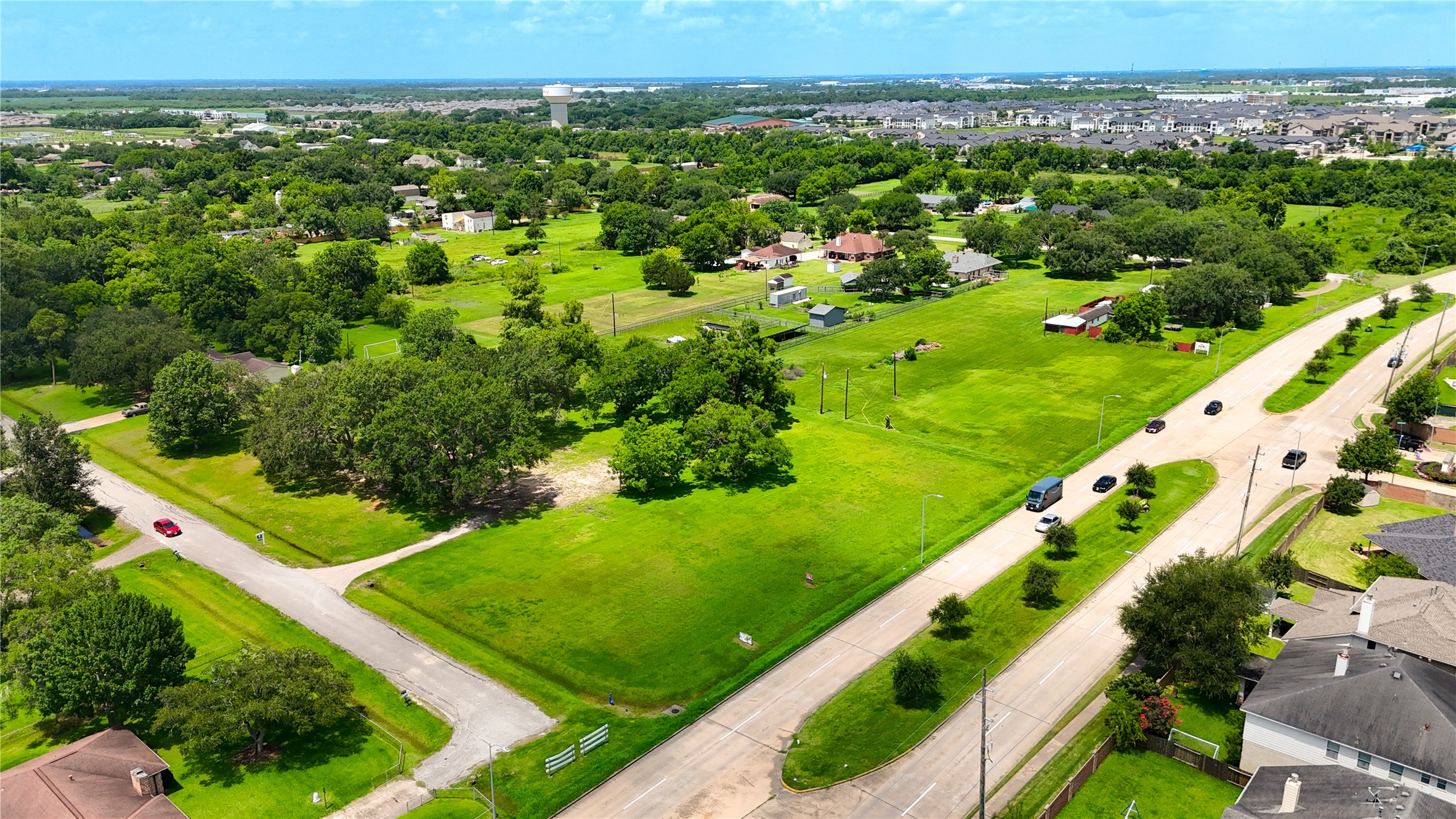 602 Sycamore Road Richmond, TX 77469 - Photo 5 of 22 an aerial view of a city with lots of green and trees