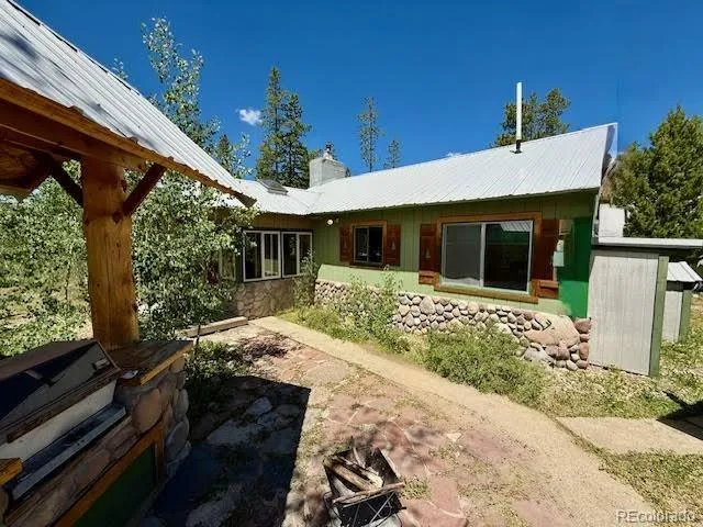 a kitchen with refrigerator and chairs