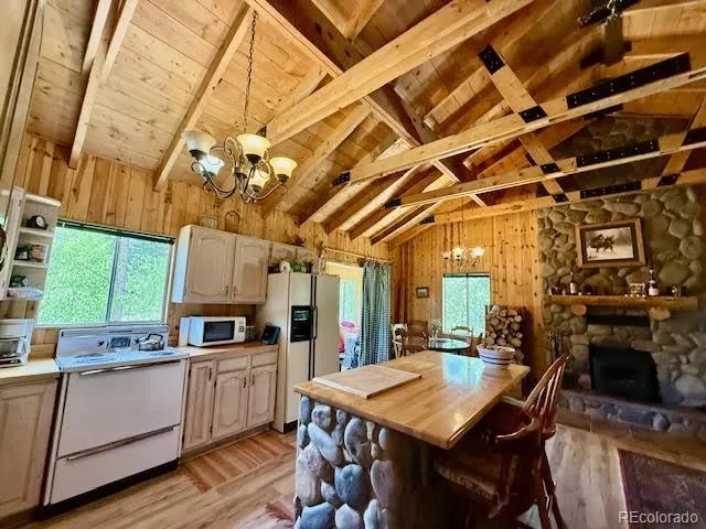 a view of a room with wooden floor and furniture