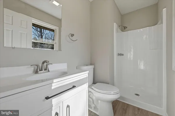 a bathroom with a toilet a sink and a shower