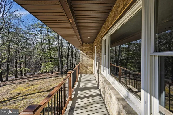 a view of balcony with wooden floor and fence