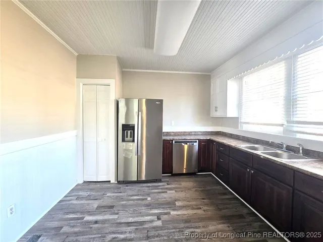 a kitchen with a refrigerator and a sink