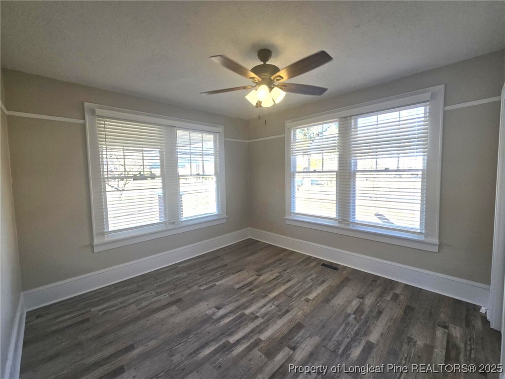 802 Dunn Road Fayetteville, NC 28312 - Photo 13 of 28 a view of an empty room with wooden floor and a window